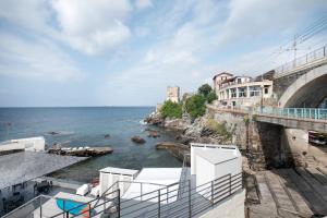 a view of the ocean and a bridge and buildings at Giada's Retreat - Genova Nervi in Genoa