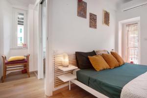 a white bedroom with a bed and a chair at Giada's Retreat - Genova Nervi in Genoa