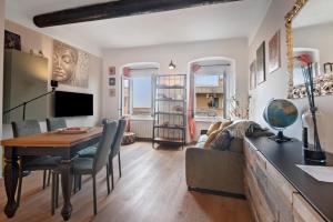 a living room with a table and a couch at Giada's Retreat - Genova Nervi in Genoa