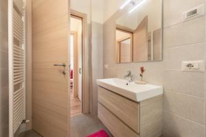 a bathroom with a sink and a mirror at Nonno Bigi Rosa in Tremosine Sul Garda