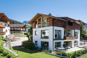 an exterior view of a house with a fence at Paruda Mountainchalet in Ortisei