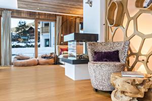 a living room with a chair and a table at Paruda Mountainchalet in Ortisei