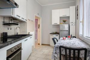 a kitchen with a table and a kitchen with white cabinets at Albachiara in Rapallo
