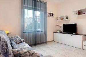 a living room with a couch and a television at Albachiara in Rapallo