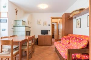 a living room with a couch and a table at Maso Noce Est in Mezzana +15 photos