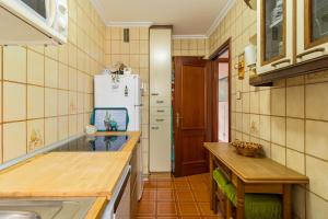 a kitchen with a sink and a refrigerator at Mila Somo in Somo +16 photos