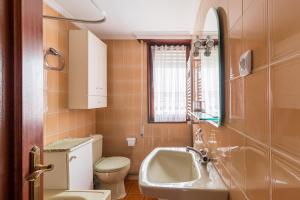 a small bathroom with a sink and a toilet at Mila Somo in Somo
