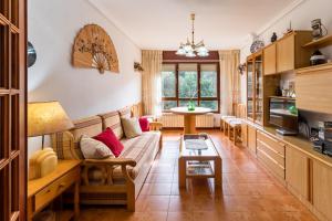 a living room with a couch and a table at Mila Somo in Somo