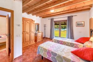 a bedroom with two beds and a window at Finca Sa Pova in Alcudia +18 photos
