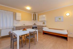 a kitchen and dining room with a table and a bed at Colleincanto Appartamento Lina in Gavardo