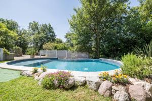 a swimming pool in a yard with flowers at Colleincanto Appartamento Lina in Gavardo