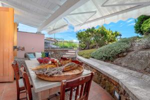 a table with a basket of food on a patio at 5 Appartamento Isuledda in San Teodoro