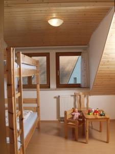 a room with two bunk beds and a table at Ferienhof Siber in Owingen