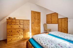 a bedroom with a bed and a dresser at Ziegelhof in Schuttertal