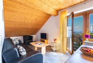 a living room with a couch and a table at Ferienhof Siber in Owingen