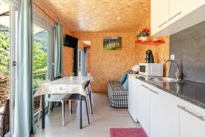 a small kitchen with a table and chairs and a window at Quintinha Da Aldida - Gerês in Vieira do Minho