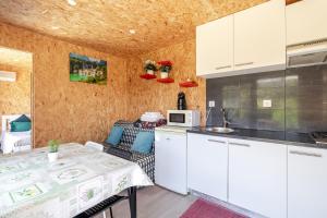 a small kitchen with a table and a microwave at Quintinha Da Aldida - Gerês in Vieira do Minho +16 photos