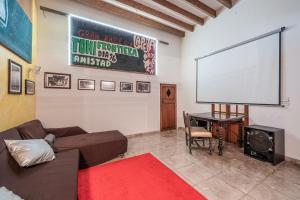 a living room with a couch and a large screen at Townhouse Can Miquel in Sa Pobla