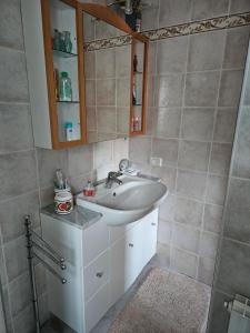 a bathroom with a sink and a mirror at Trilocale a Santa Maria Maggiore in Santa Maria Maggiore