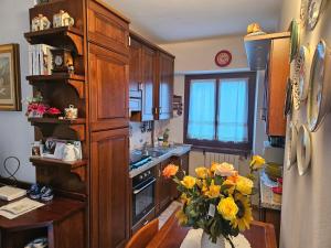 a kitchen with a vase of flowers on a table at Trilocale a Santa Maria Maggiore in Santa Maria Maggiore