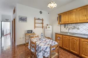 a kitchen with a table and a refrigerator at Apartamento Nayara A in Calera +13 photos