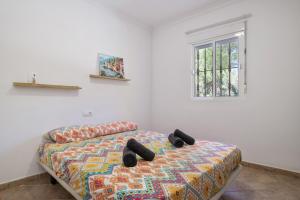 a bedroom with a bed and a window at Chalet Independiete Con Piscina in Cádiz +20 photos
