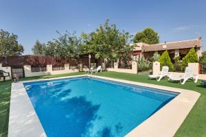 a swimming pool in the yard of a house at Capricho in Cieza