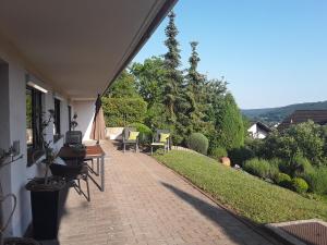 a patio with chairs and a table on the side of a house at Ferienwohnung Bieniussa 3 in Gemünden