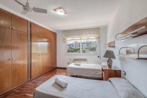 a bedroom with two beds and a couch and a window at Villa Masnou in El Masnou +36 photos