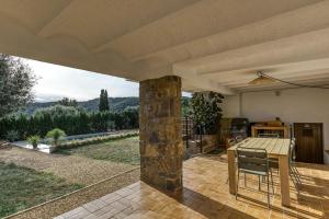 a kitchen with a table and chairs on a patio at Villa Les Aulines in Calonge