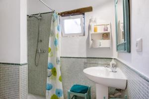 a bathroom with a sink and a shower at La Posada de la Pinaleta in Chiclana de la Frontera +38 photos