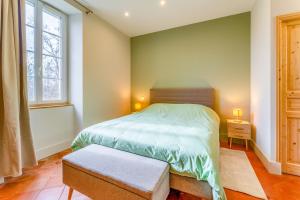 a small bedroom with a bed and a window at Mas Saint Louis in Avignon