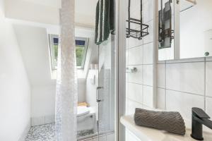 a bathroom with a shower and a sink at Großes Ferienhaus Engelsdorf in Zweifelscheid +37 photos