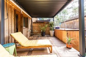 an outdoor patio with a couch and a table at Les Ptis Chiffons in Lacanau