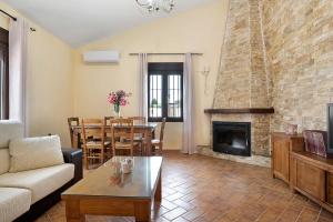 a living room with a couch and a fireplace at Casa Sonia y Nuria in Roche