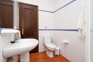 a white bathroom with a sink and a toilet at Chalet Bellavista in Conil de la Frontera +17 photos