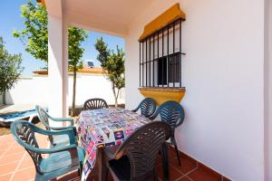 a table and chairs on the porch of a house at Chalet Bellavista in Conil de la Frontera