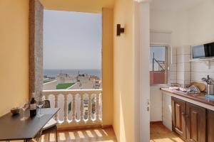 a kitchen with a balcony with a view of the ocean at Loft Pension Candelaria in Valle Gran Rey