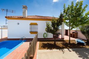 a villa with a swimming pool and a house at Chalet Bellavista in Conil de la Frontera