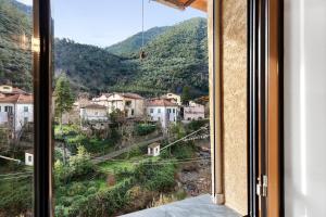 a window with a view of a mountain at Casa vacanza A Cola - con Jacuzzi in Rocchetta Nervina