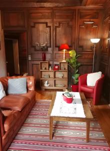 a living room with a couch and a table at Maison des Princes de Monaco in Vic-sur-Cère +3 photos