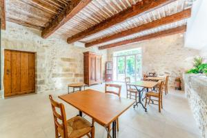 a living room with a wooden table and chairs at Mas Saint Louis in Avignon