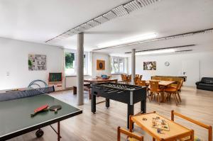a living room with a ping pong table at Ferienhof Siber in Owingen