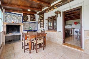 a dining room with a table and a fireplace at Casa Rural Benjamin en Deltebre in Deltebre