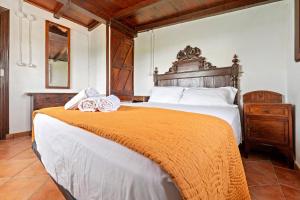 a bedroom with a large bed with an orange blanket at Casa Rural Benjamin en Deltebre in Deltebre +18 photos
