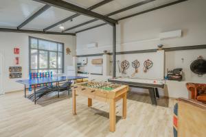 a room with two ping pong tables and a pool table at La Antigua Taberna - Nieva in Nieva