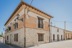 a brick building with windows on a street at La Antigua Taberna - Nieva in Nieva