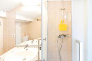 a bathroom with a sink and a shower at Charmant T2 centre Capbreton in Capbreton +15 photos