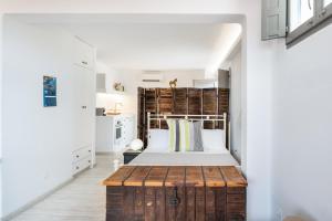 a bedroom with a bed and a wooden chest in a room at Luna Rossa Milos - Lavender in Provatas