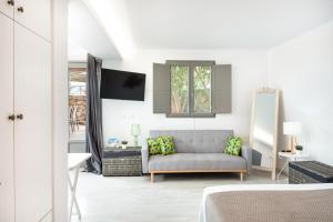 a living room with a couch and a window at Luna Rossa Milos - Lavender in Provatas
